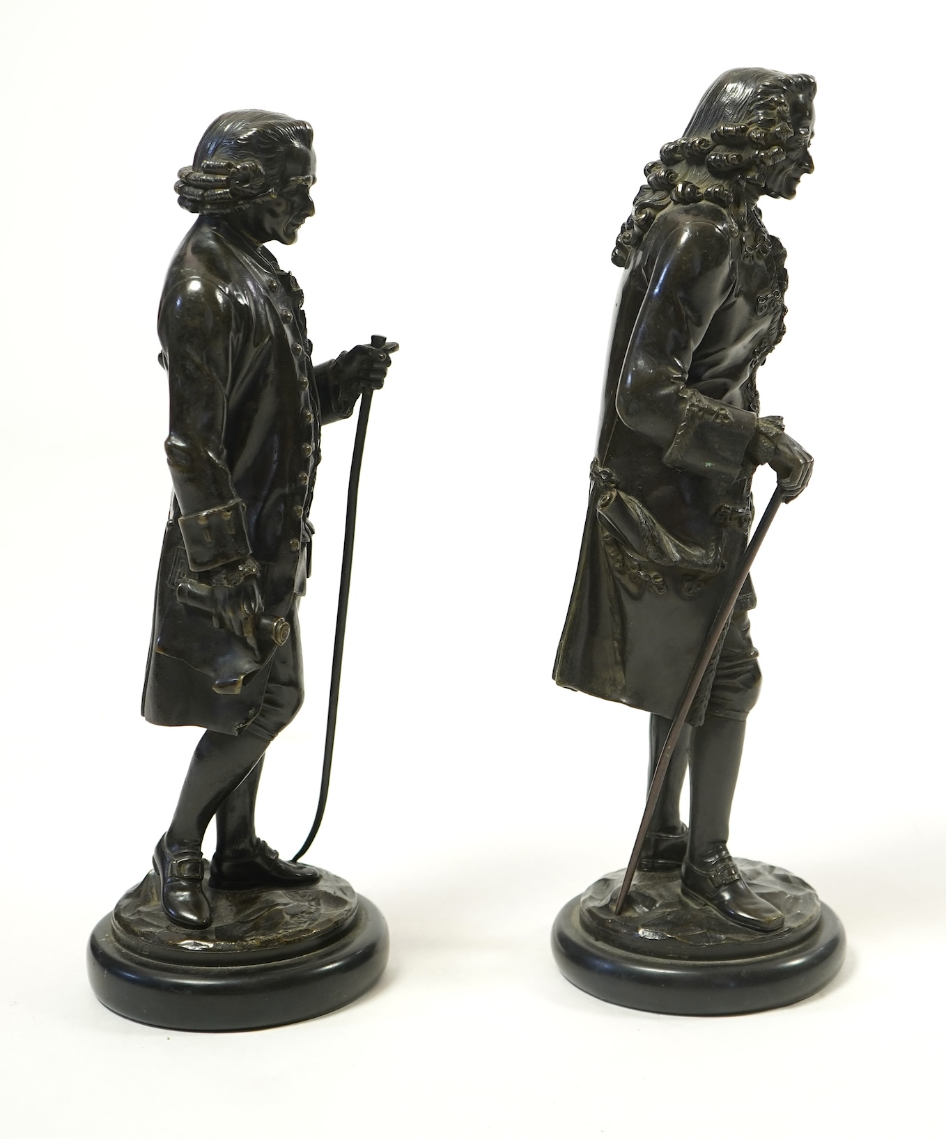 After Jean-Claude-Joseph Rosset (1706-1786), two patinated bronze figures of Voltaire and Jean-Jacques Rousseau, 19th century